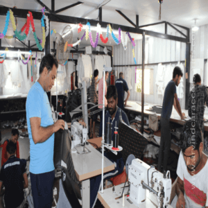 A group of workers operating sewing machines in a factory, manufacturing car seat covers