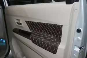 the interior of a car with the door pad work.