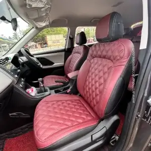 the inside of a car with red leather seat covers