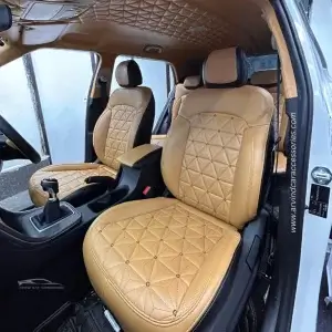 Car interior upgraded with tan leather upholstery and matching headliner.