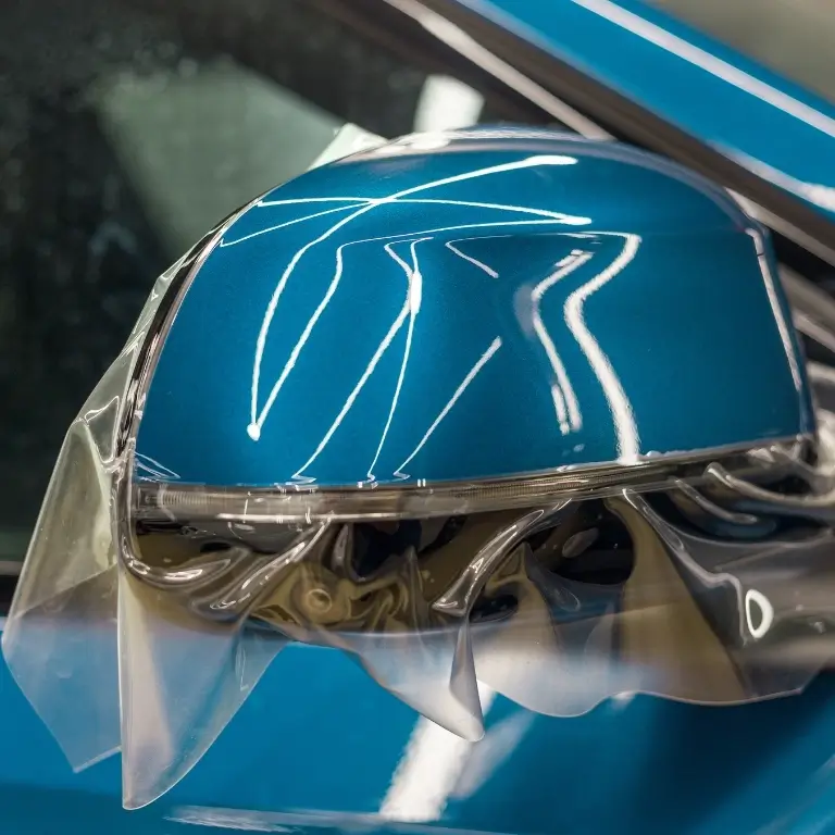 Car mirror with protective film applied